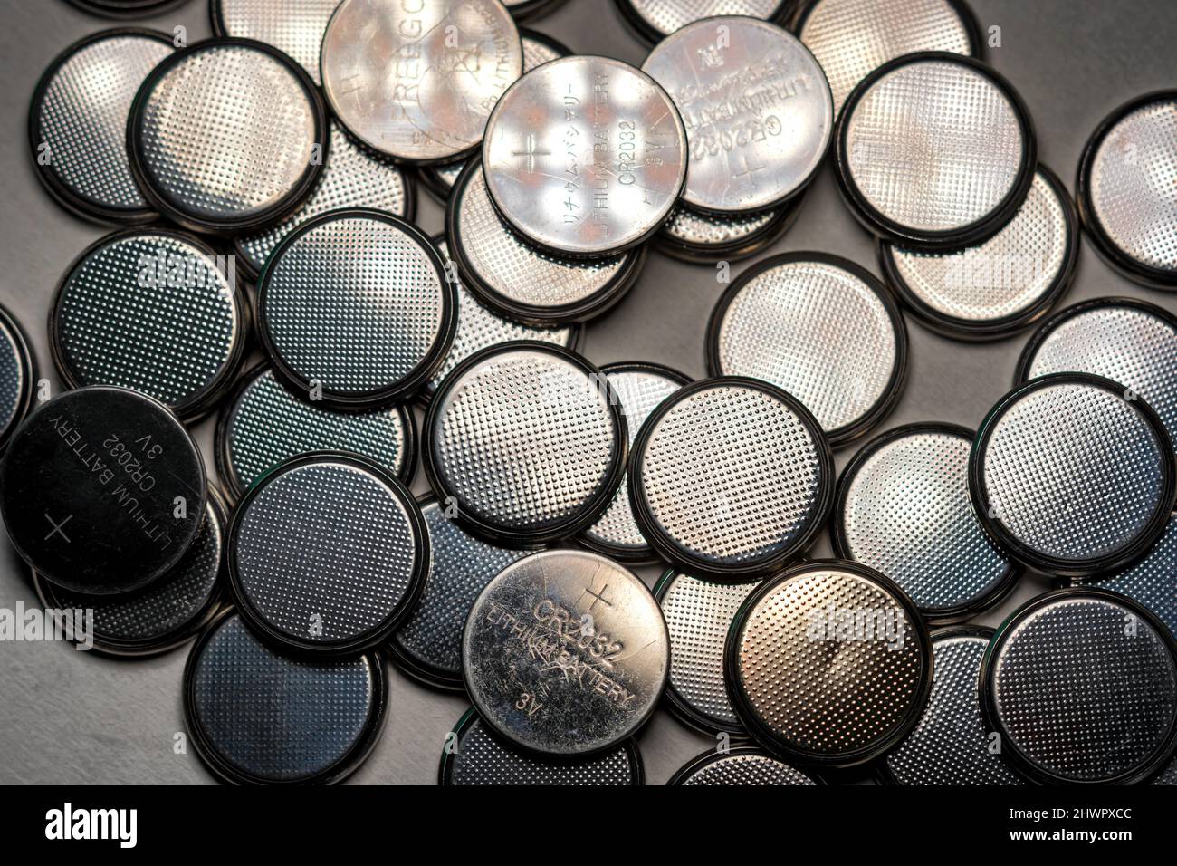 CR2032 coin cell batteries background closeup pan slide Stock Photo - Alamy