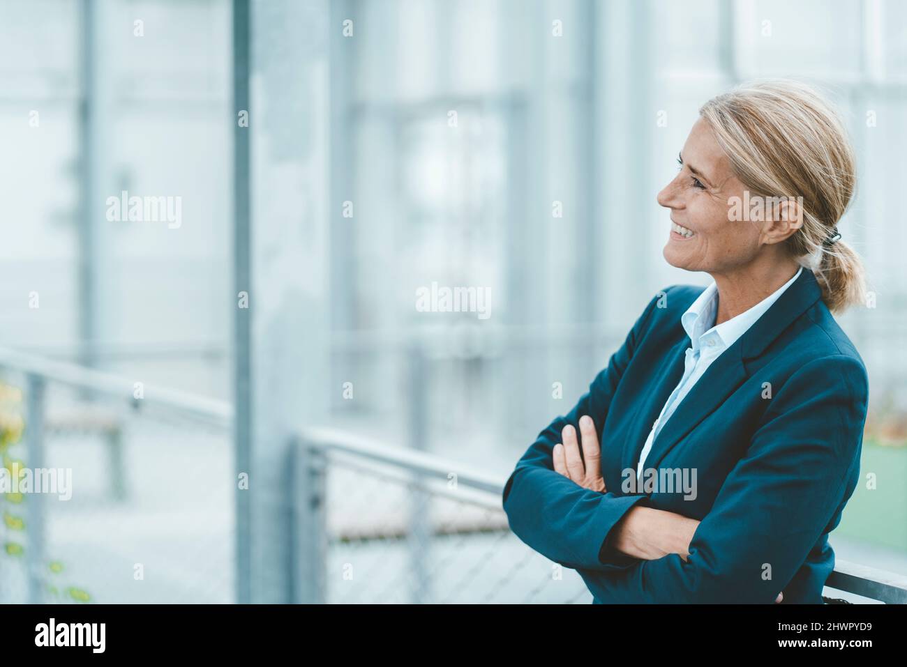 Happy businesswoman with arms crossed in office Stock Photo - Alamy