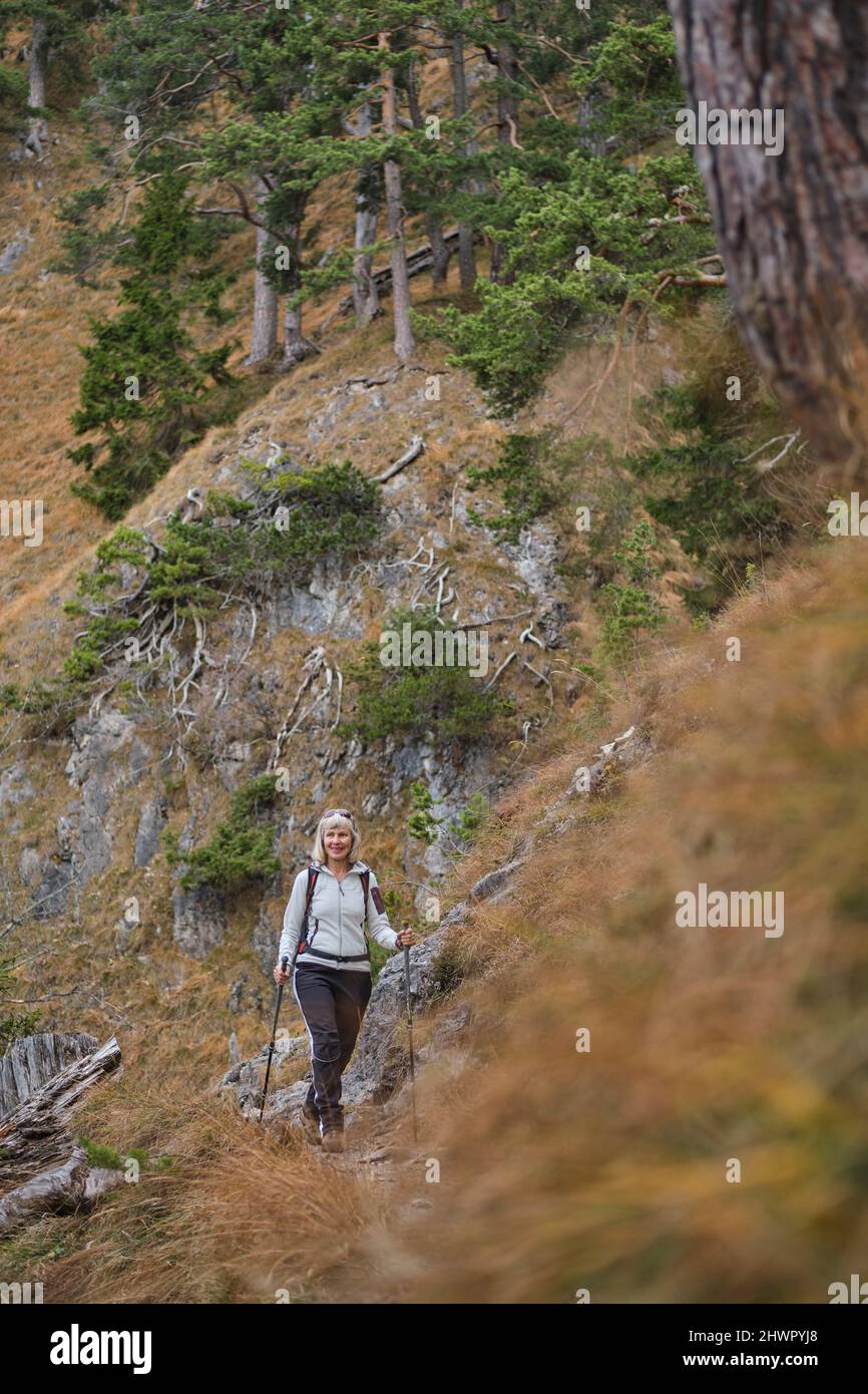 Senior woman hiking in mountain Stock Photo