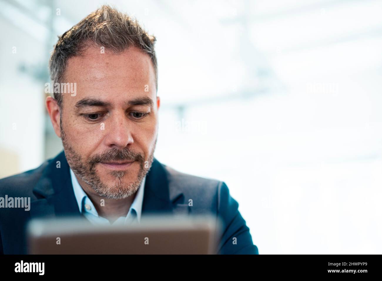 Businessman using tablet PC at workplace Stock Photo