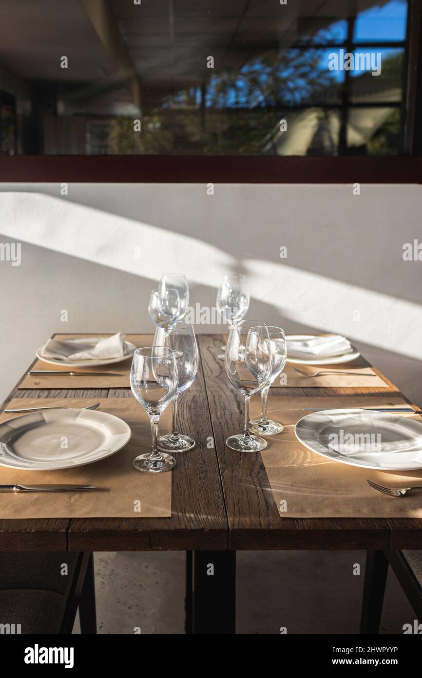 Plates and wineglasses on table in restaurant Stock Photo