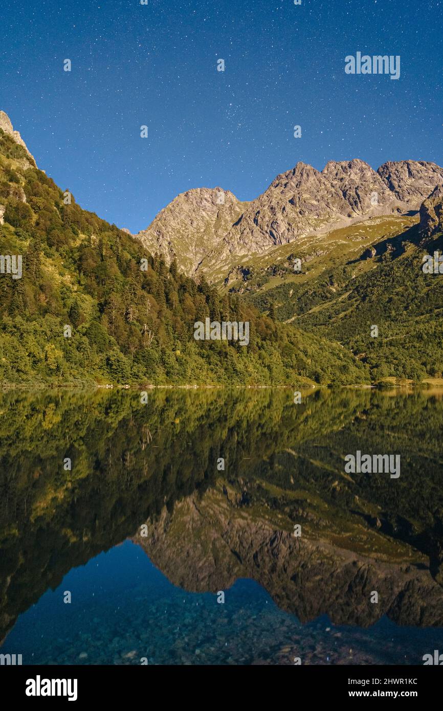 Reflection of Caucasus Mountain in lake at night, Sochi, Russia Stock Photo