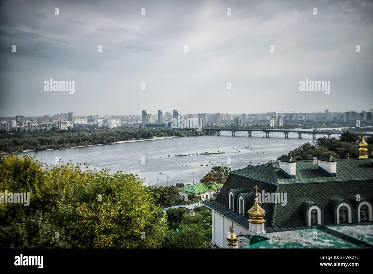 Panoramic view of Kiev with rooftops in the foreground and the river Dnieper in the background Stock Photo