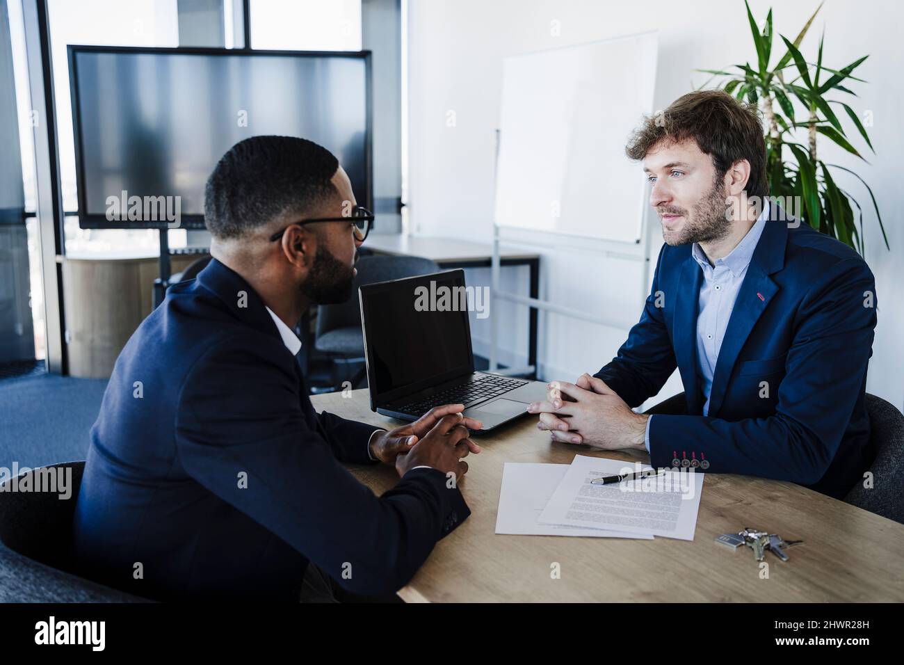 Talking with client with computer hi-res stock photography and images ...