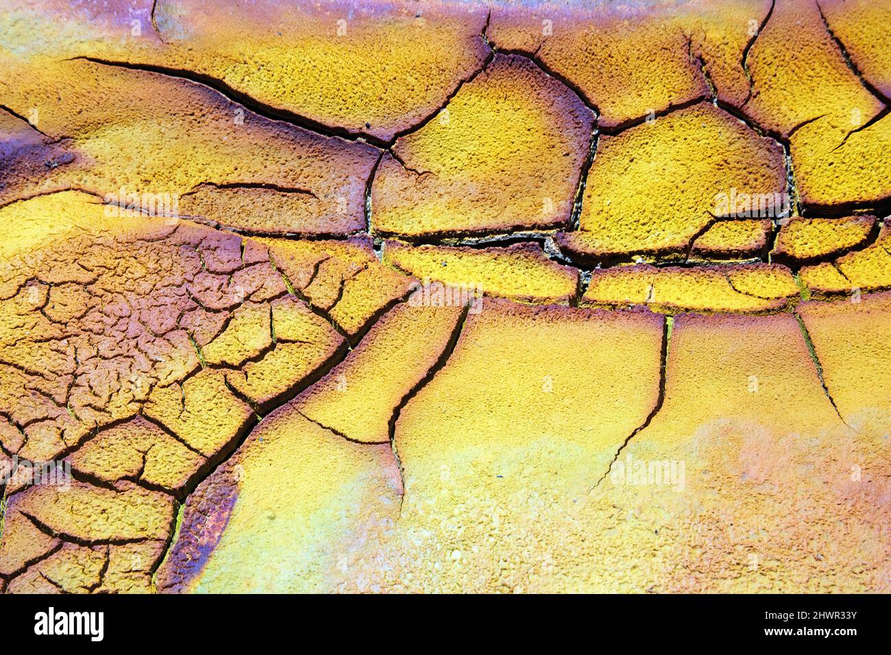 Full frame of dry cracked soil on bank of Rio Tinto Stock Photo