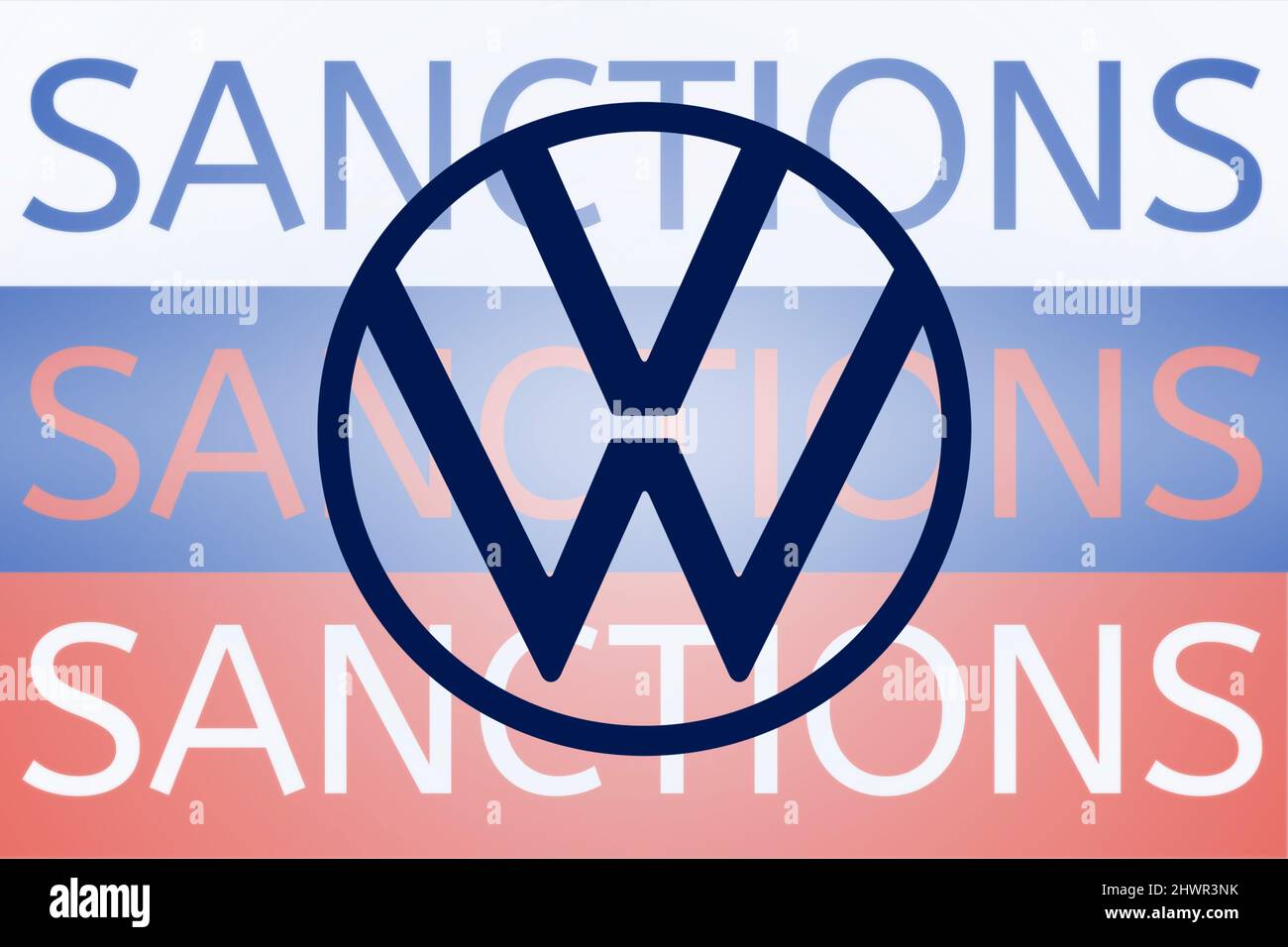 VW Volkswagen logo in front of the sanction text on the Russian flag. Fresh sanctions against Russia over its invasion of Ukraine. March 2022, San Francisco, USA Stock Photo