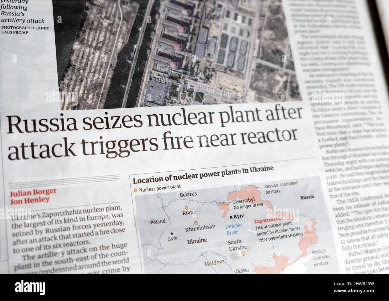 'Russia seizes nuclear plant after attack triggers fire near reactor' Russian forces attack Guardian newspaper headline 4 March 2022 London England UK Stock Photo