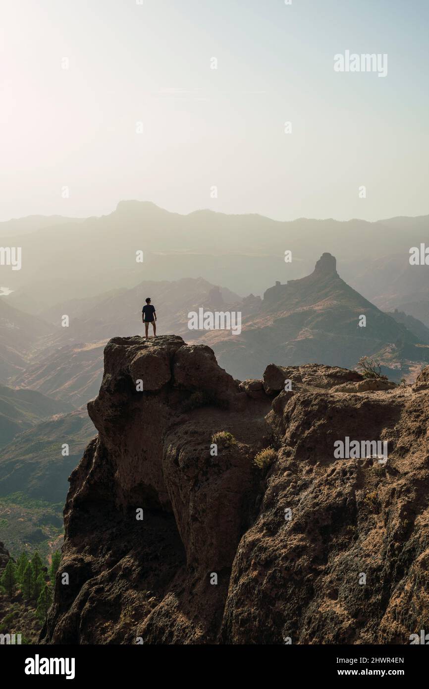 Man standing on mountain peak, Grand Canary, Spain Stock Photo