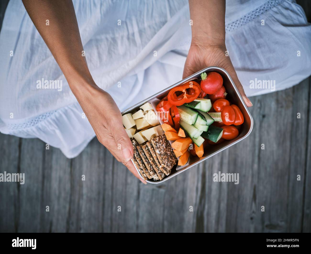 Woman sitting with lunch box Stock Photo - Alamy