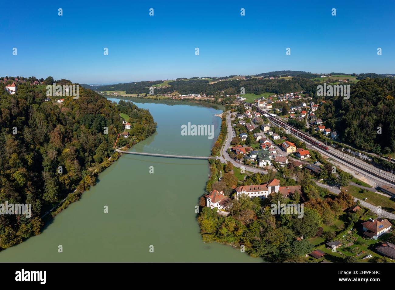 Austria, Upper Austria, Wernstein am Inn, Aerial view of river Inn in summer with Mariensteg bridge in background Stock Photo