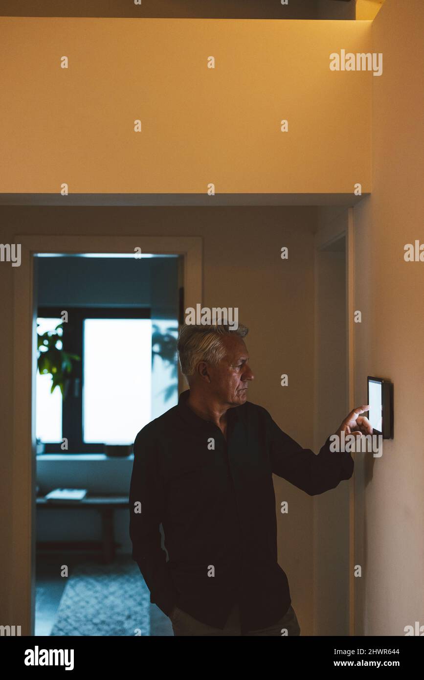 Senior man using tablet PC at smart home Stock Photo