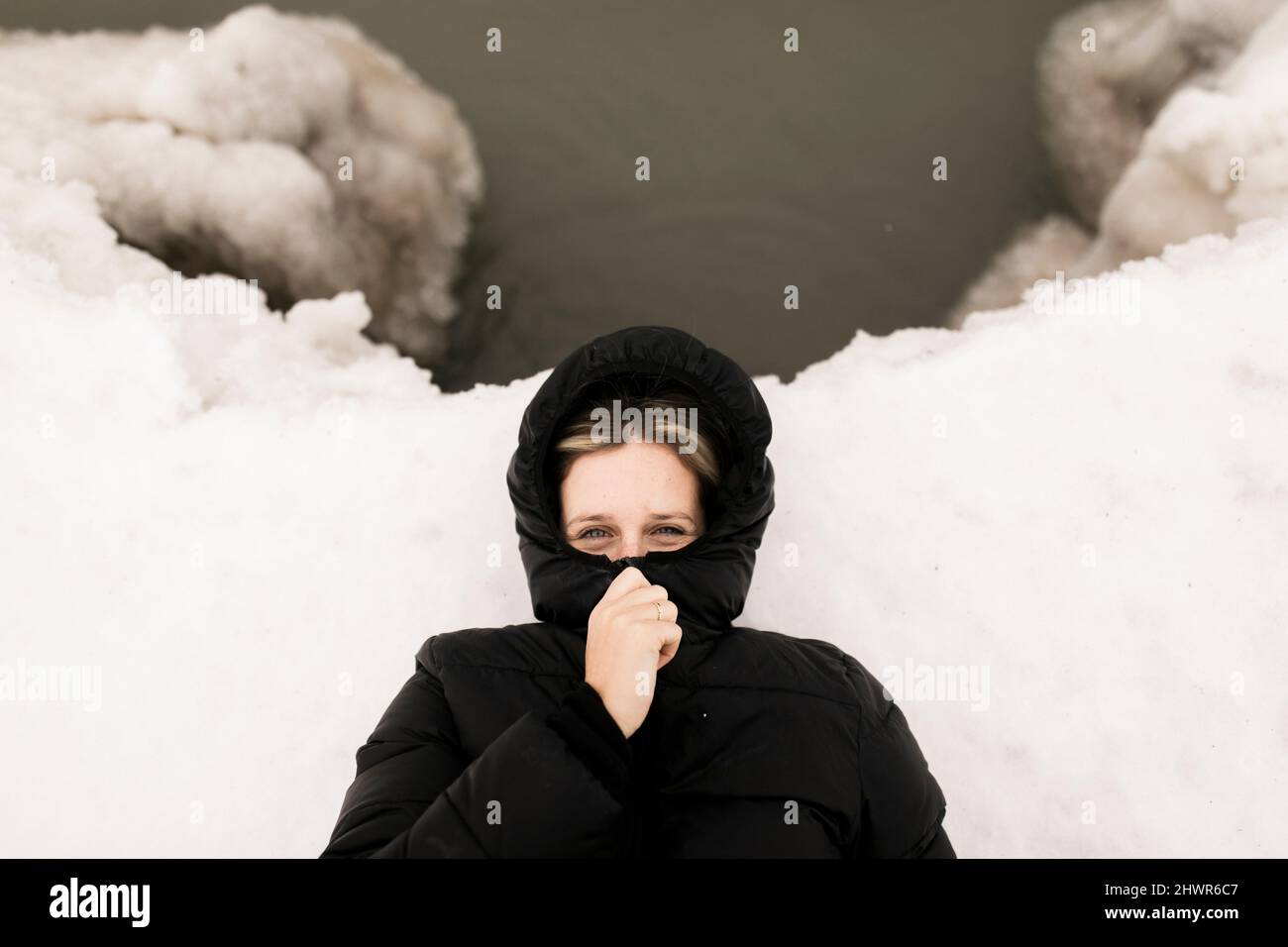 Woman lying in snow hi-res stock photography and images - Alamy