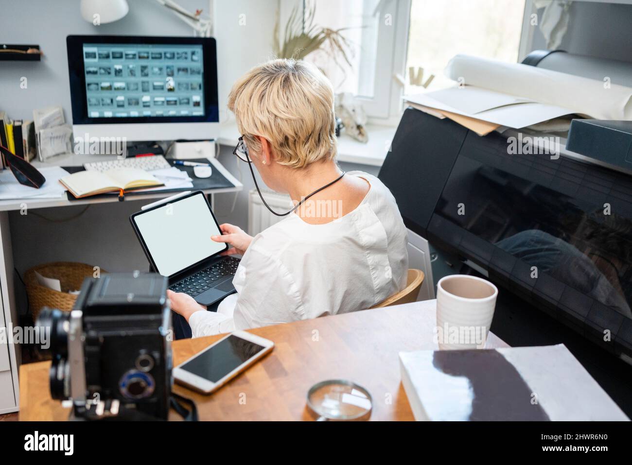 Blond woman using tablet PC in office Stock Photo