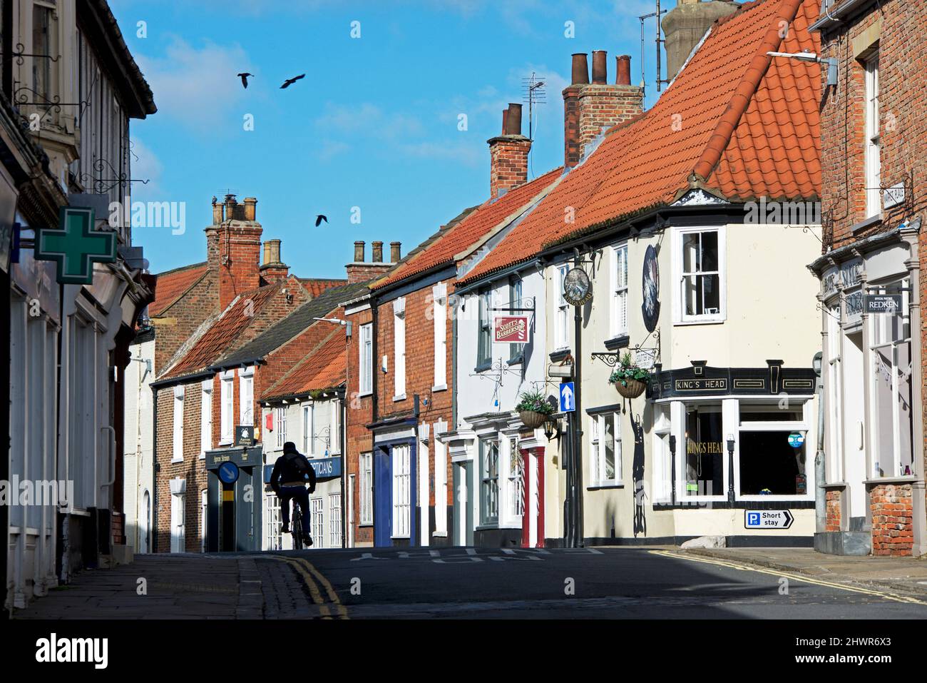 Boy cyling on Souter Gate in Hedon, East Yorkshire, England UK Stock
