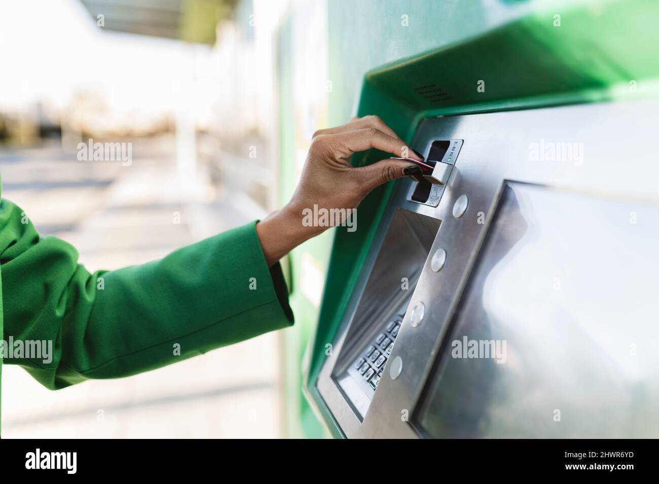 Businesswoman's hand inserting smart card in ticket machine Stock Photo