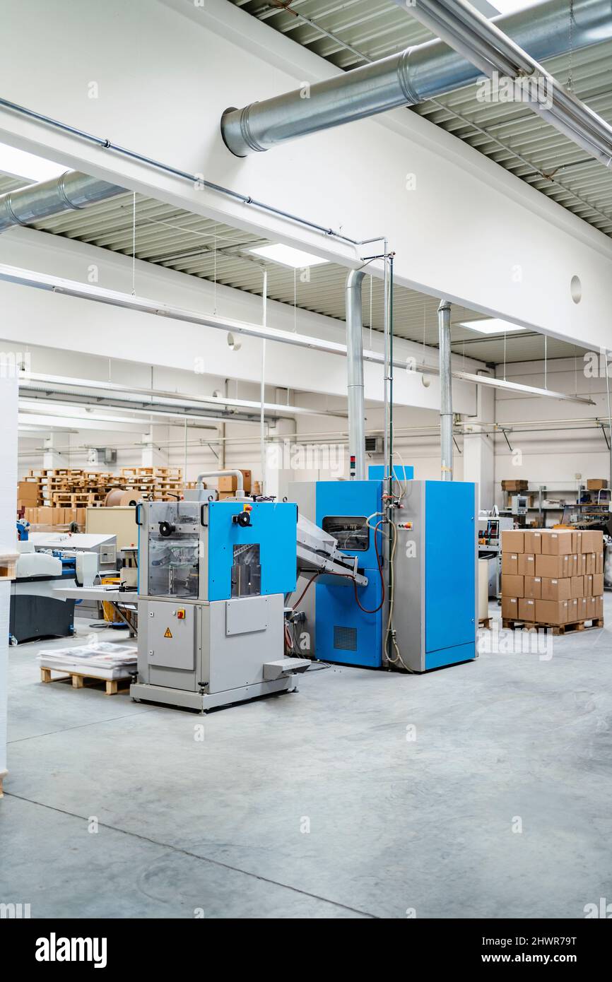 Cardboard boxes arranged by machinery in factory Stock Photo Alamy