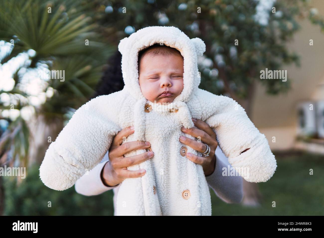 Mother holding cute son in garden Stock Photo