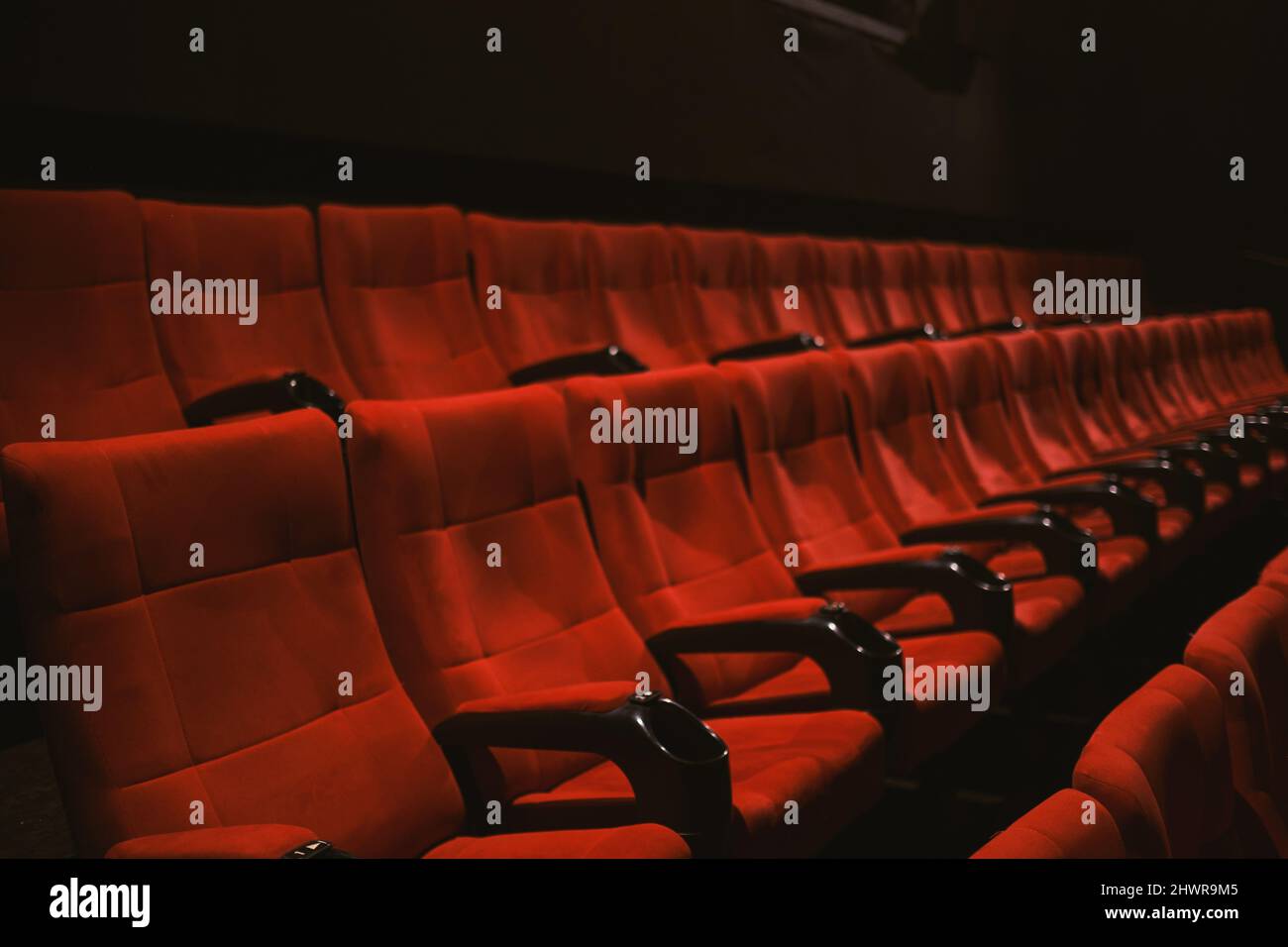 Red colored cinema seats with no people. Stock Photo