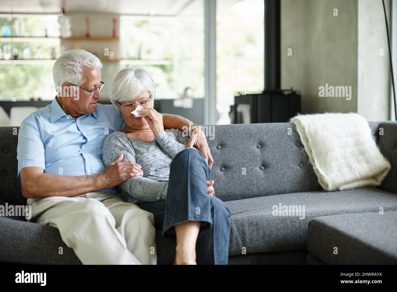 I cant believe what happened. Shot of a senior man consoling his wife. Stock Photo