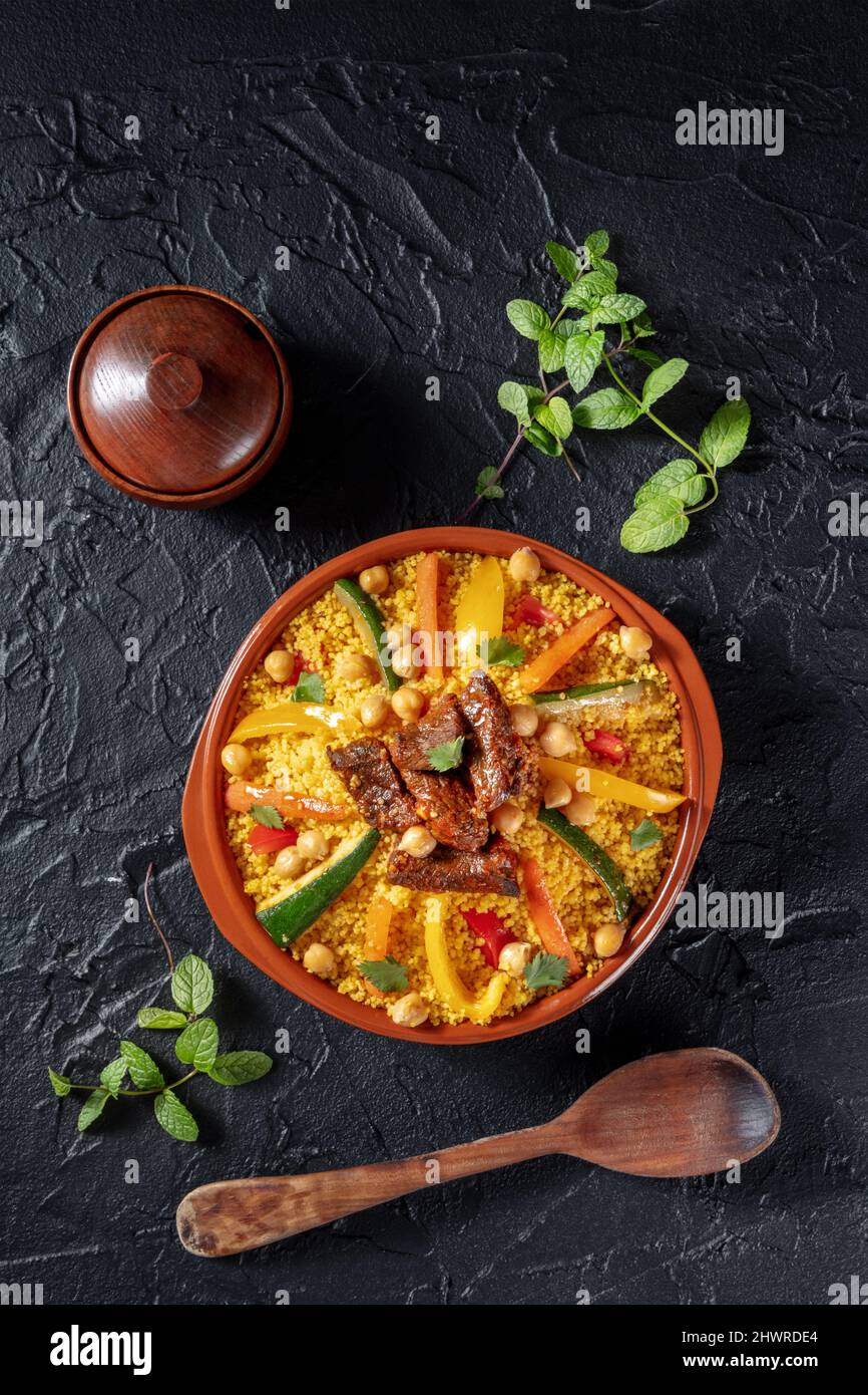 Couscous with meat and vegetables, traditional Moroccan food, shot from