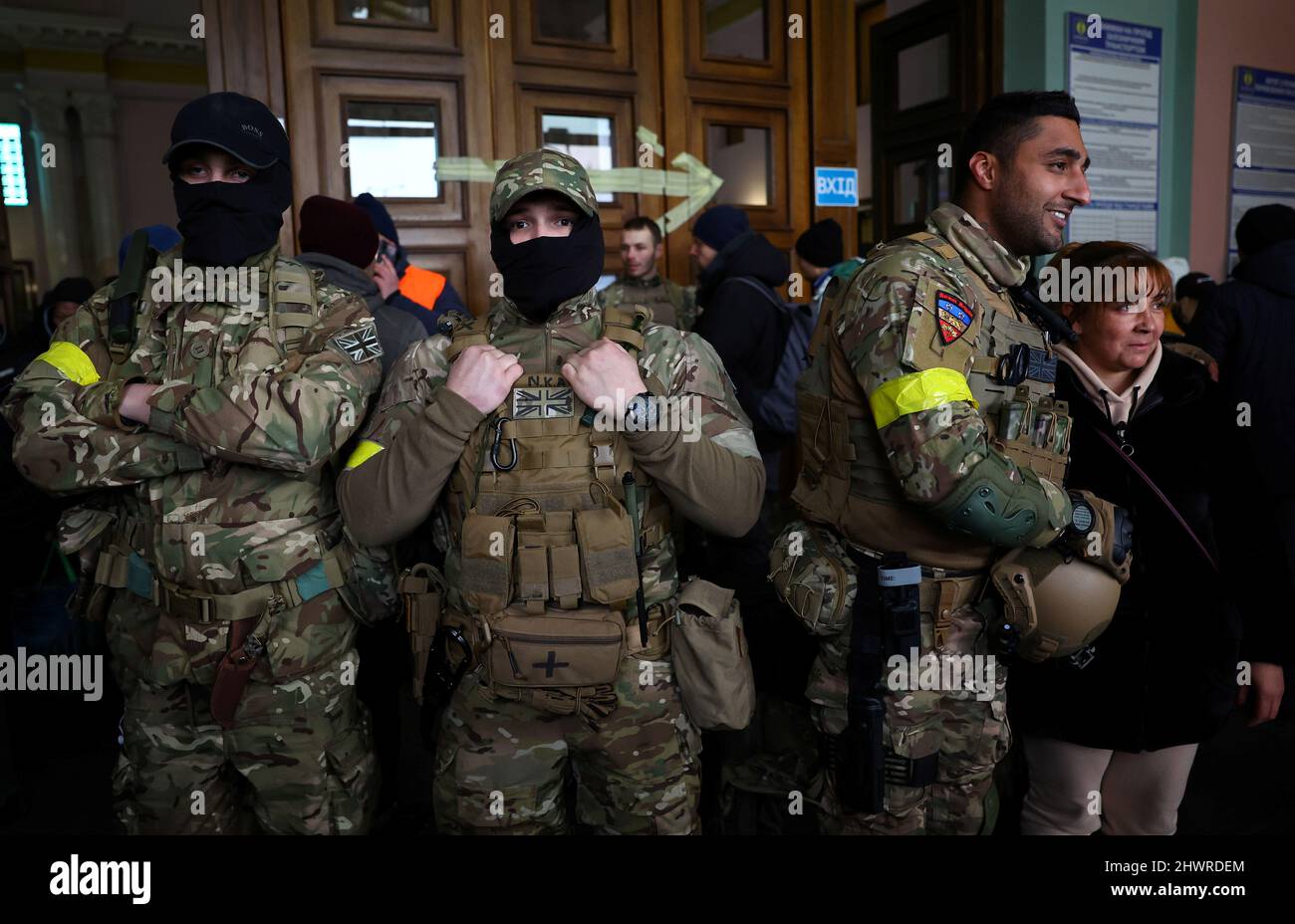 Foreign fighters from the UK asked to be identified as 'Scouser', 'Jacks' and 'Ben Grant' pose for a picture as they are ready to depart towards the front line in the east of Ukraine following the Russian invasion, at the main train station in Lviv, Ukraine, March 5, 2022. Picture taken March 5, 2022.   REUTERS/Kai Pfaffenbach Stock Photo