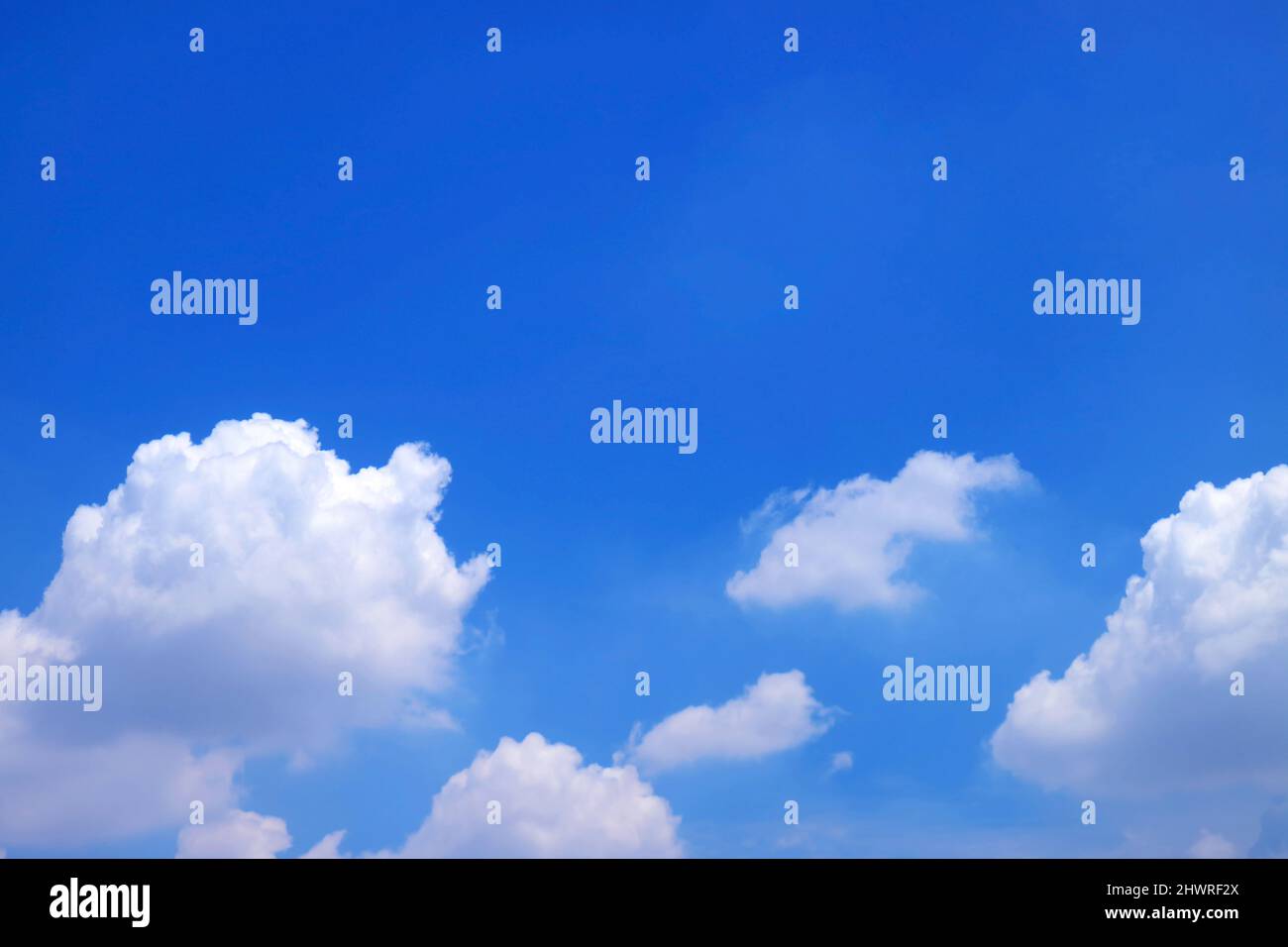 Vivid Blue Sky with Floating Pure White Cumulus Clouds Stock Photo - Alamy
