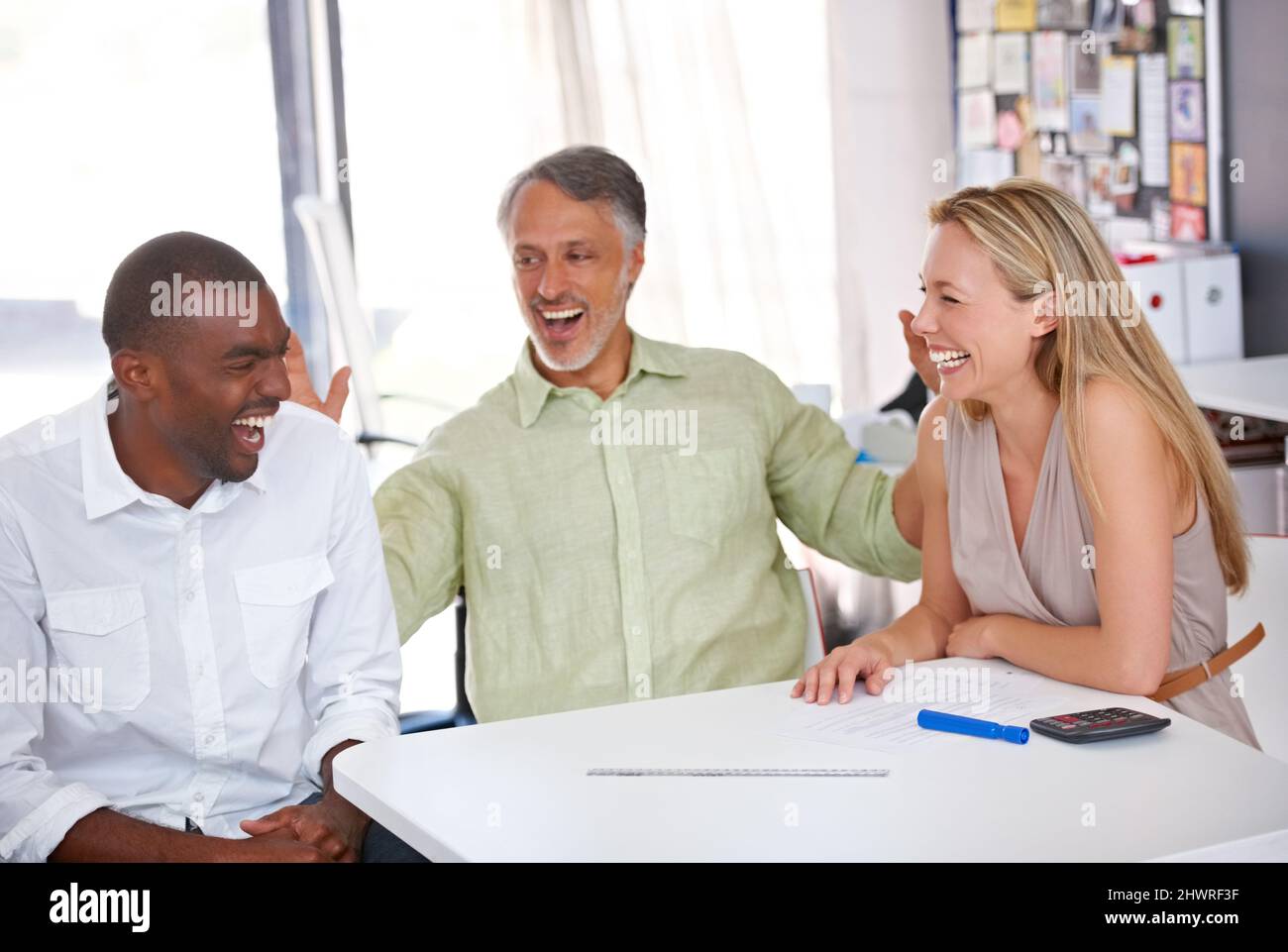 Working together on a great design. Three designers having a meeting. Stock Photo
