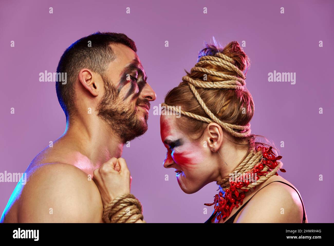 Beautiful young acrobats or gymnasts with colorful face painting on ...
