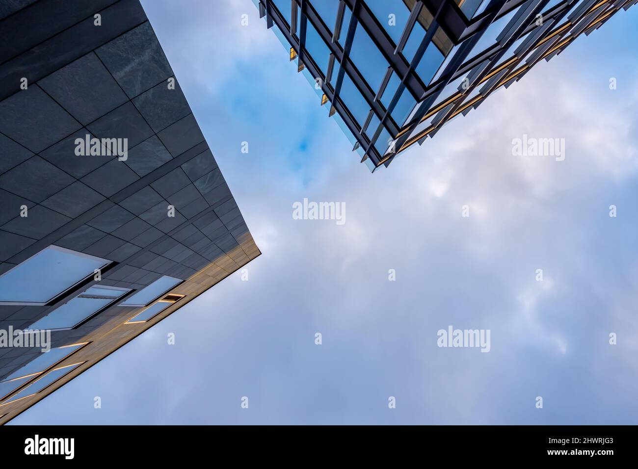 Facade of a modern apartament building against a blue sky background ...