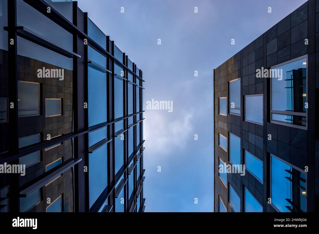 Facade of a modern apartament building against a blue sky background ...