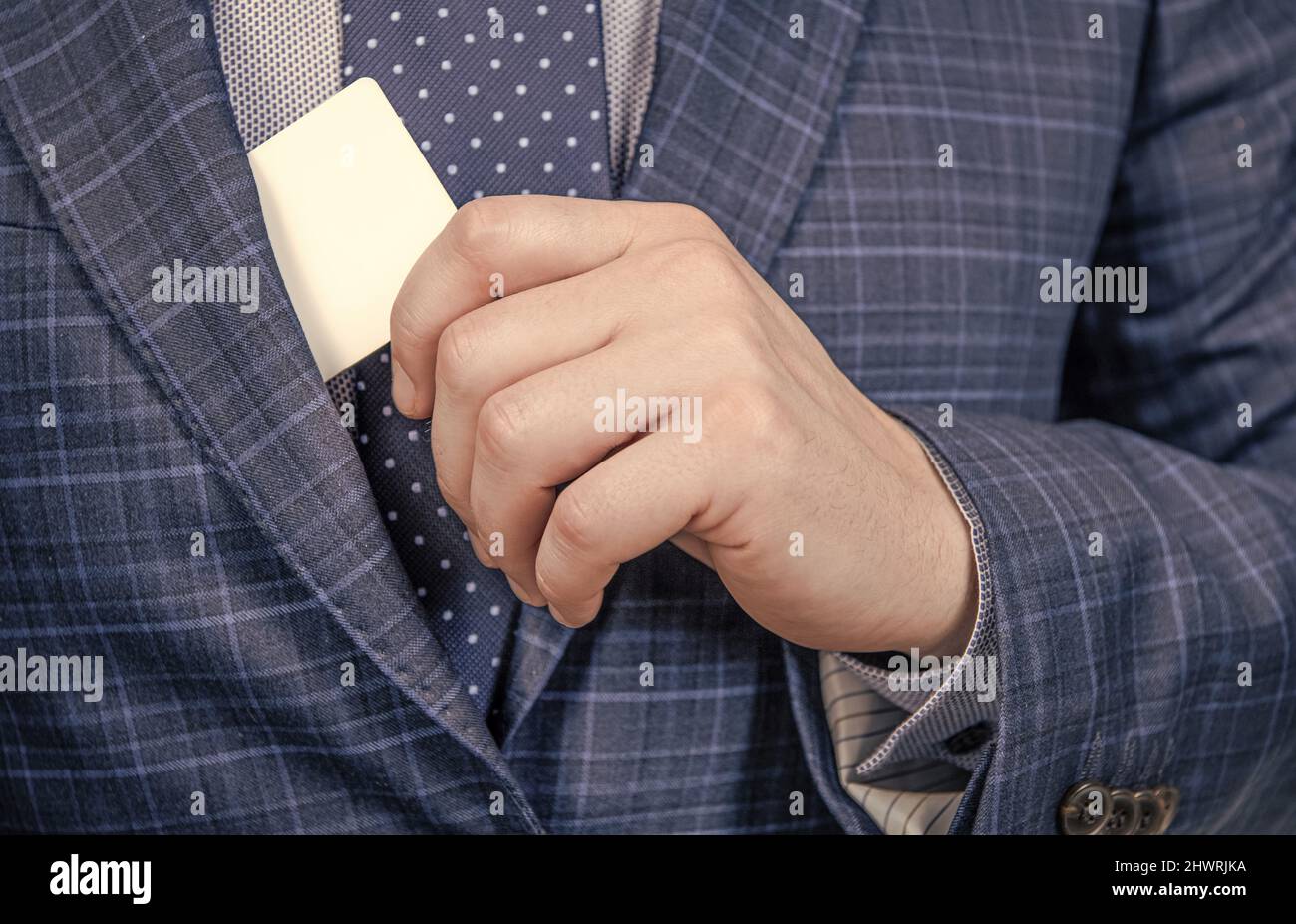 Male hand pull identity card from formal suit jacket cropped view, identification, copy space Stock Photo