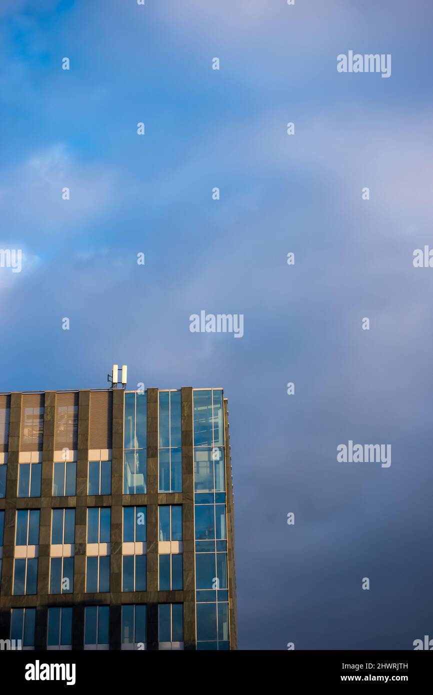 Facade of a modern apartament building against a blue sky background ...