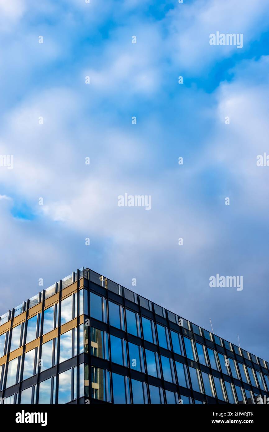 Facade of a modern apartament building against a blue sky background ...