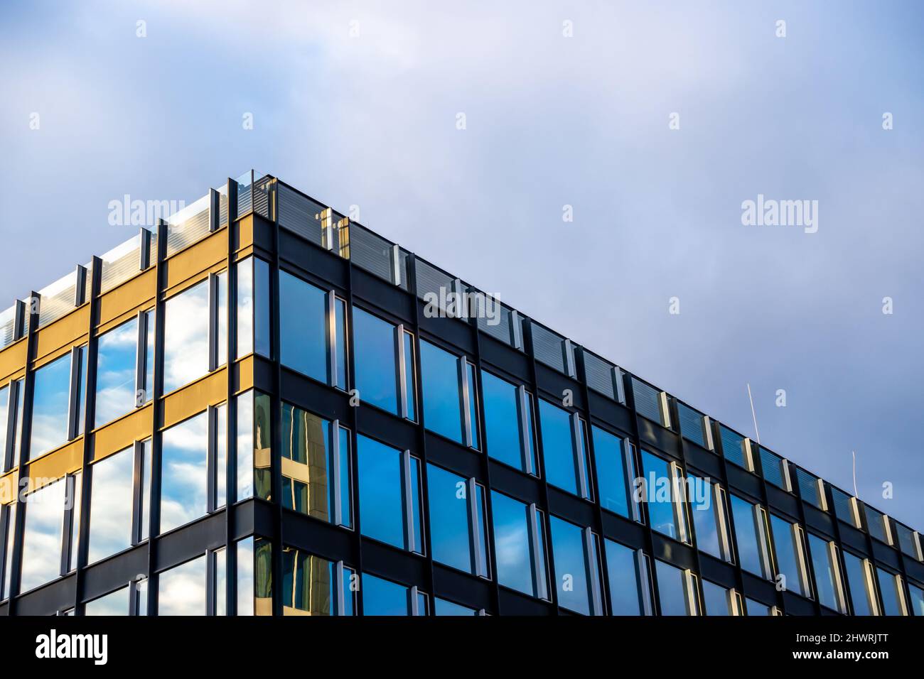 Facade of a modern apartament building against a blue sky background ...