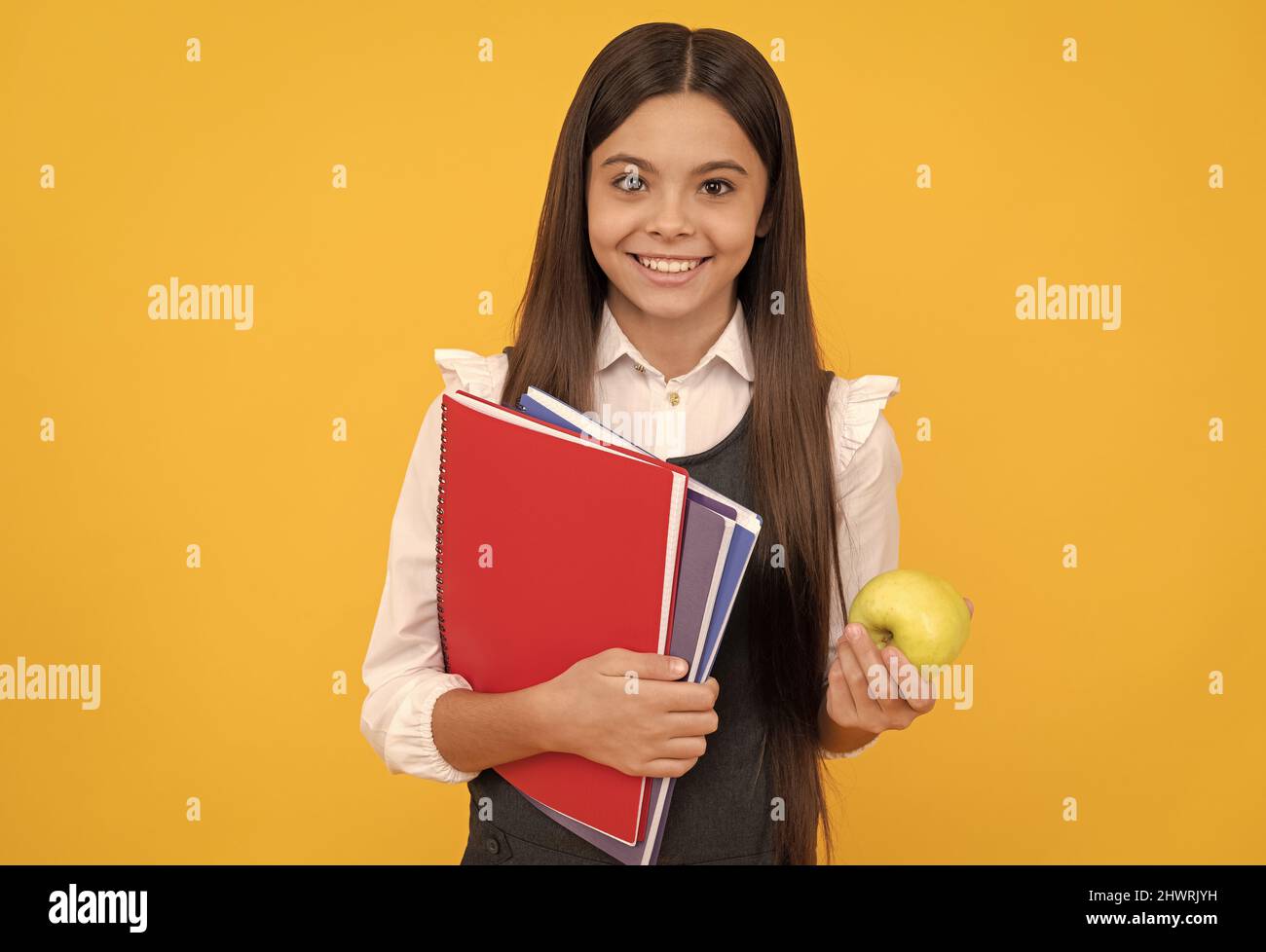 Knowledge is delicious. Happy schoolchild hold apple and books. Knowledge day Stock Photo