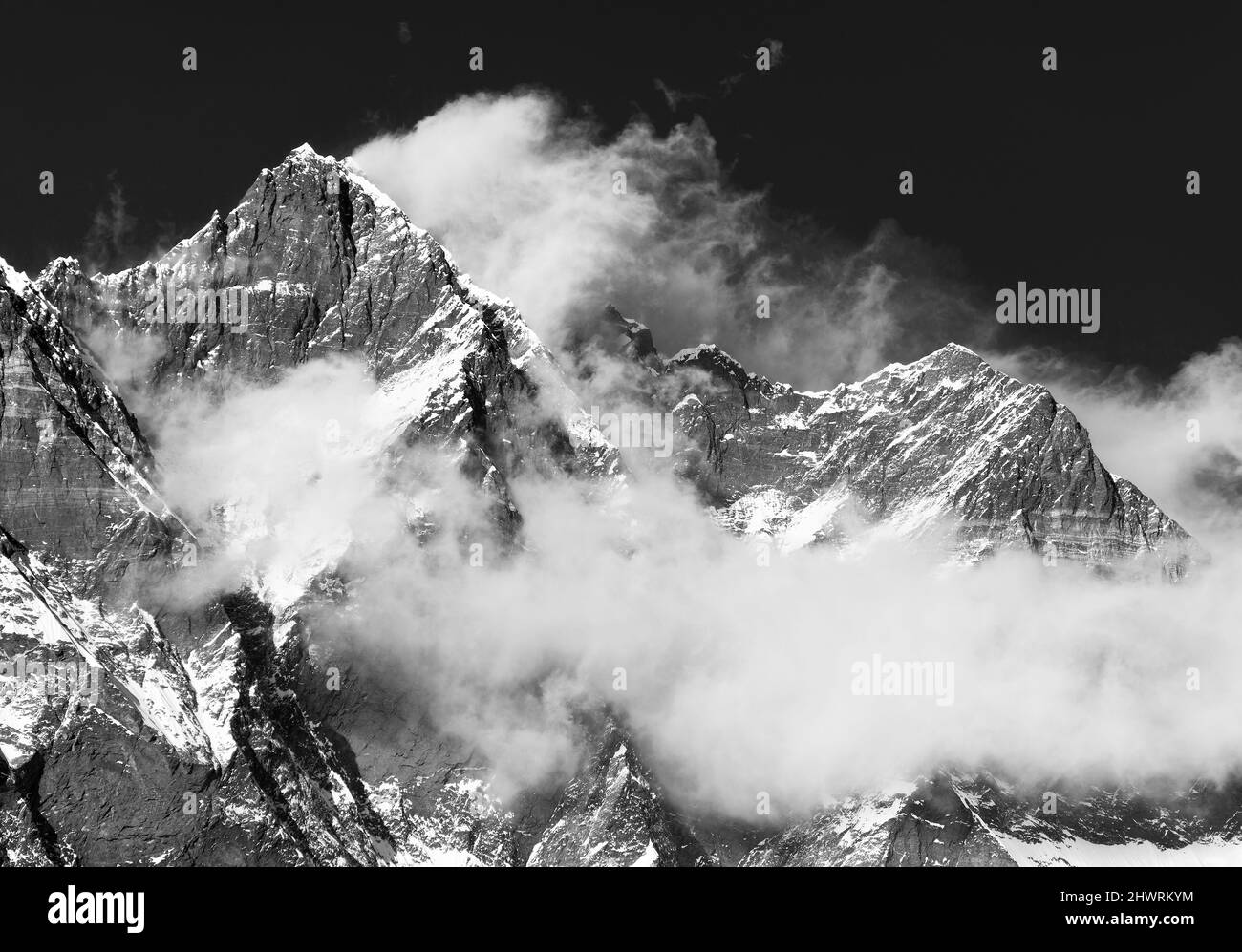 Mount Lhotse with clouds on the top - way to mount Everest base camp, Khumbu valley, Sagarmatha national park, Nepalese Himalayas mountains, black and Stock Photo