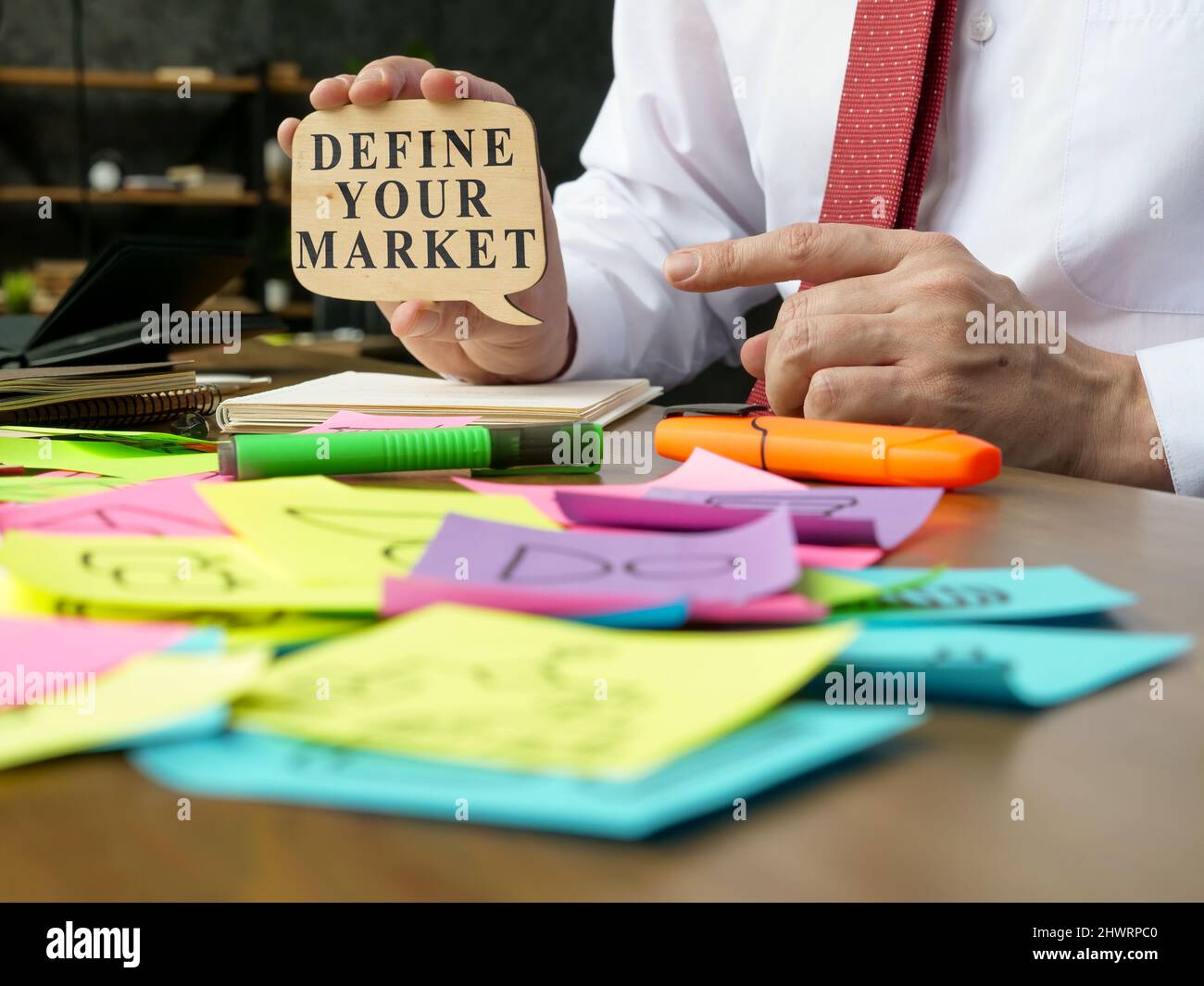 The manager points to the sign with define your market words. Stock Photo