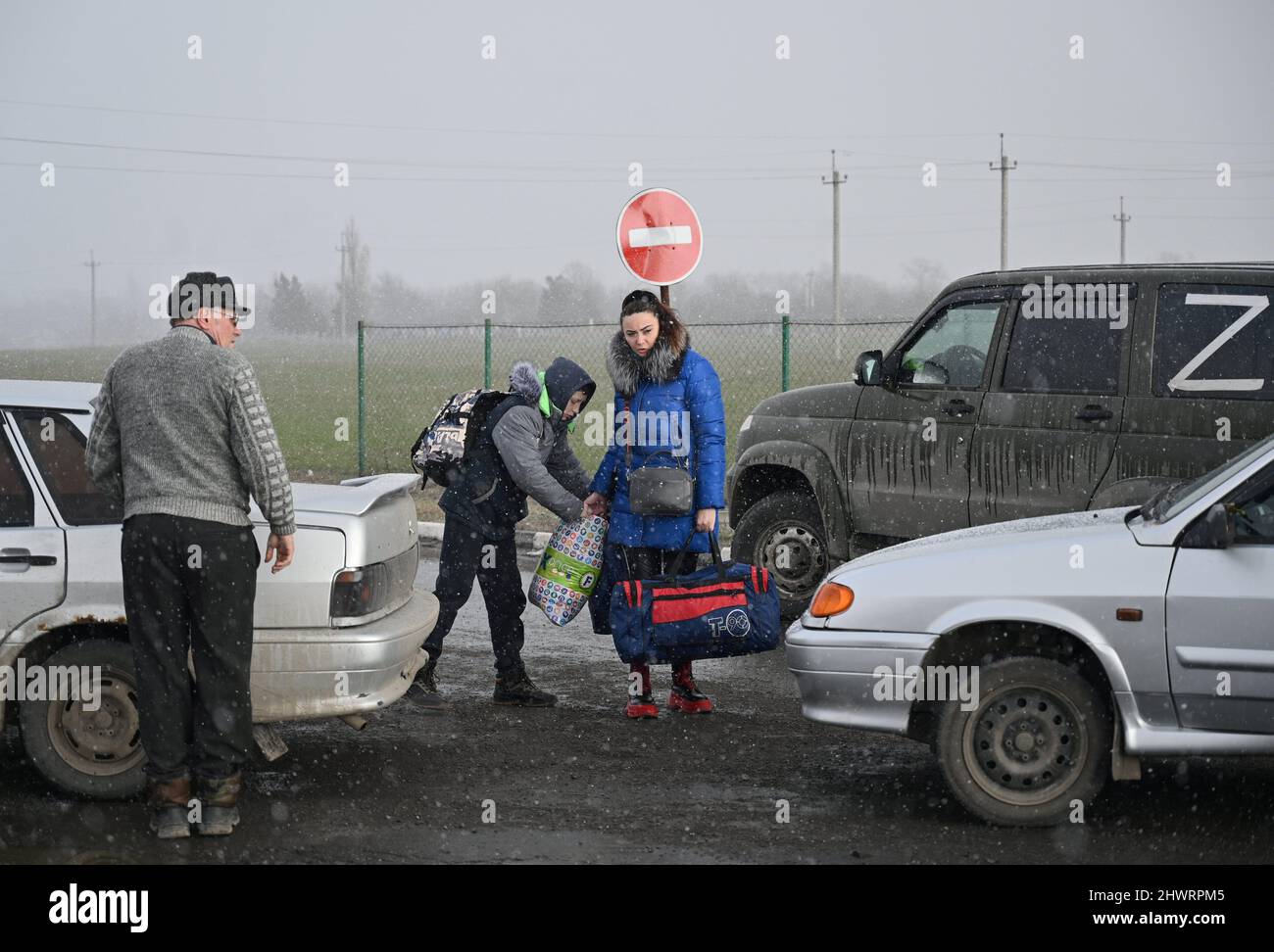 People arrive at the Veselo-Voznesenka border crossing after fleeing from Ukraine to Russia during Ukraine-Russia conflict, in the Rostov region, Russia March 7, 2022. REUTERS/REUTERS PHOTOGRAPHER Stock Photo