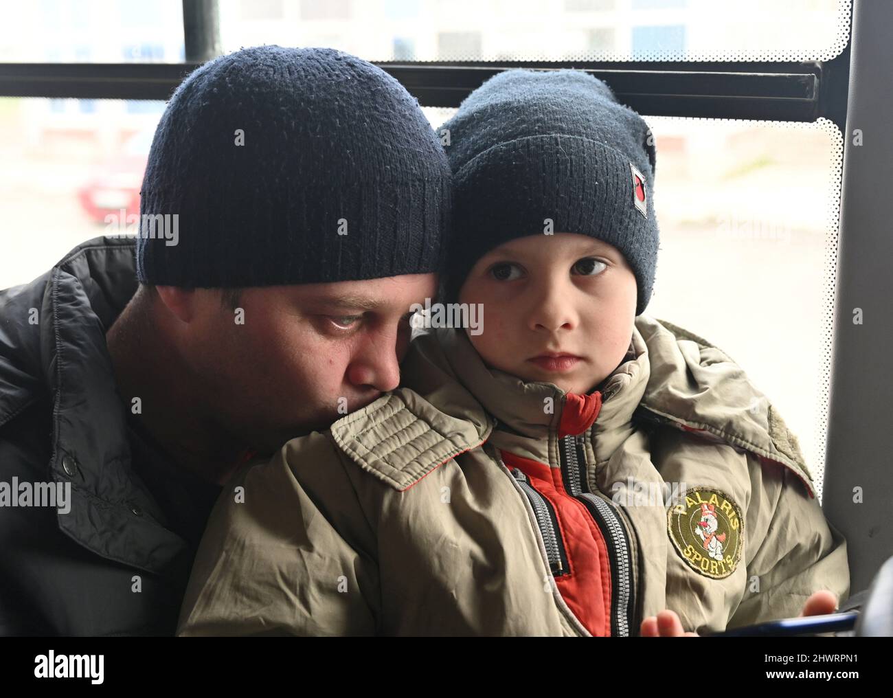 People sit inside a bus after fleeing from Ukraine to Russia during Ukraine-Russia conflict, at the Veselo-Voznesenka border crossing in the Rostov region, Russia March 7, 2022. REUTERS/REUTERS PHOTOGRAPHER Stock Photo