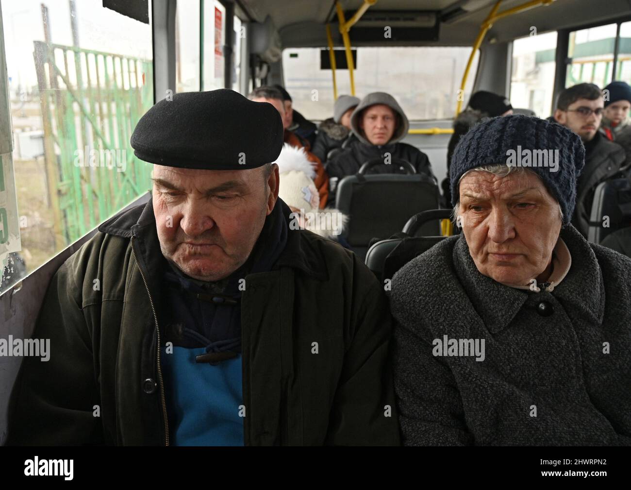 People sit inside a bus after fleeing from Ukraine to Russia during Ukraine-Russia conflict, at the Veselo-Voznesenka border crossing in the Rostov region, Russia March 7, 2022. REUTERS/REUTERS PHOTOGRAPHER Stock Photo