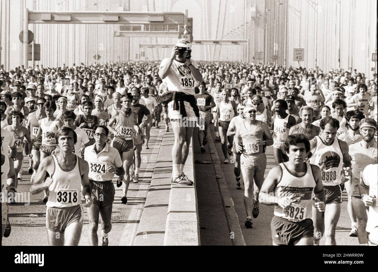 At the start oof the 1981 New York Marathon, a photographer pauses to take a picture. On the Verrazzano Bridge during mile1 of the race. Stock Photo