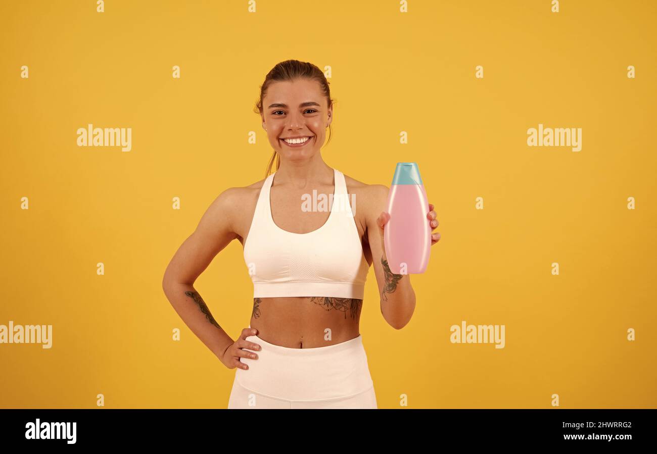 happy girl presenting cosmetic product. woman use shower gel. lady