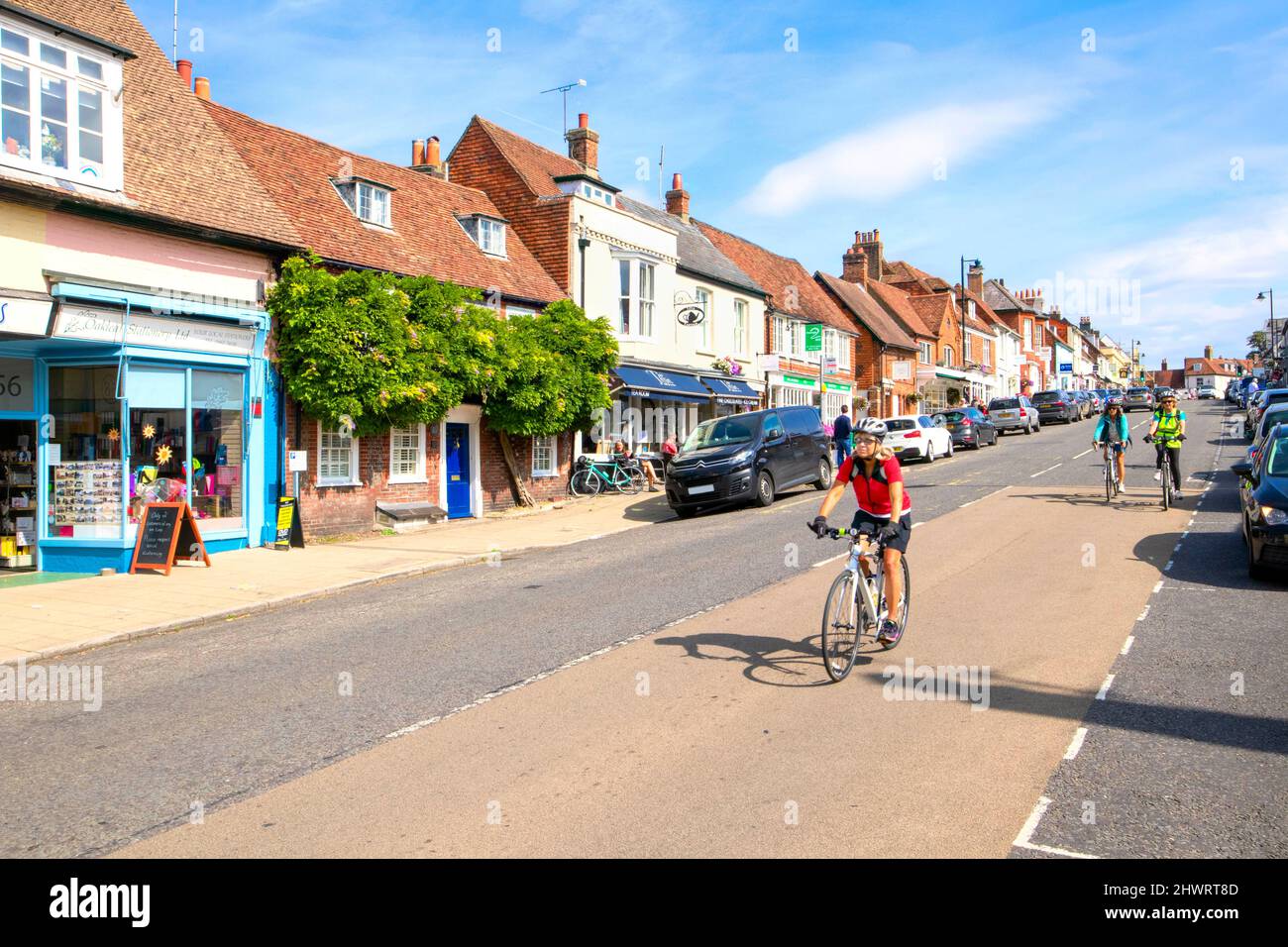 Cyclists riding down West Street, New Alresford, Hampshire, England UK Stock Photo