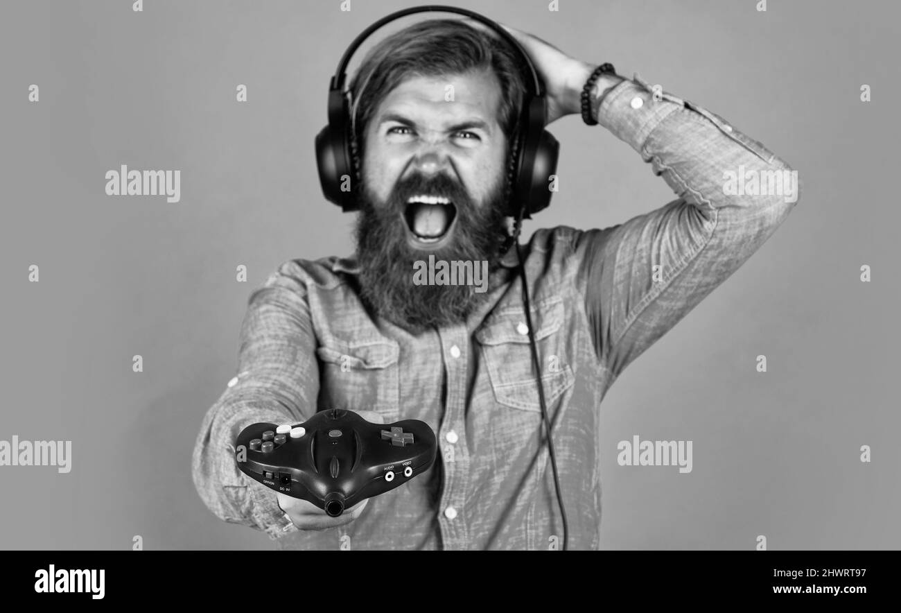 oh no. concept of tv gaming. man in headphones with console. hobby. just have fun. new technology in modern life. happy gamer play computer games. man Stock Photo