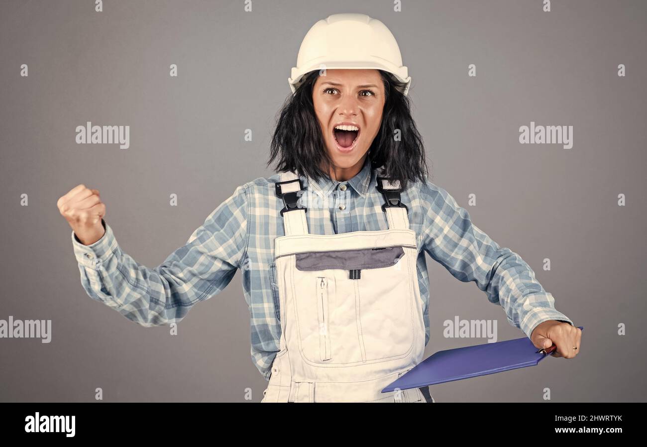 smiling female architect in safety hard hat, blueprint Stock Photo - Alamy
