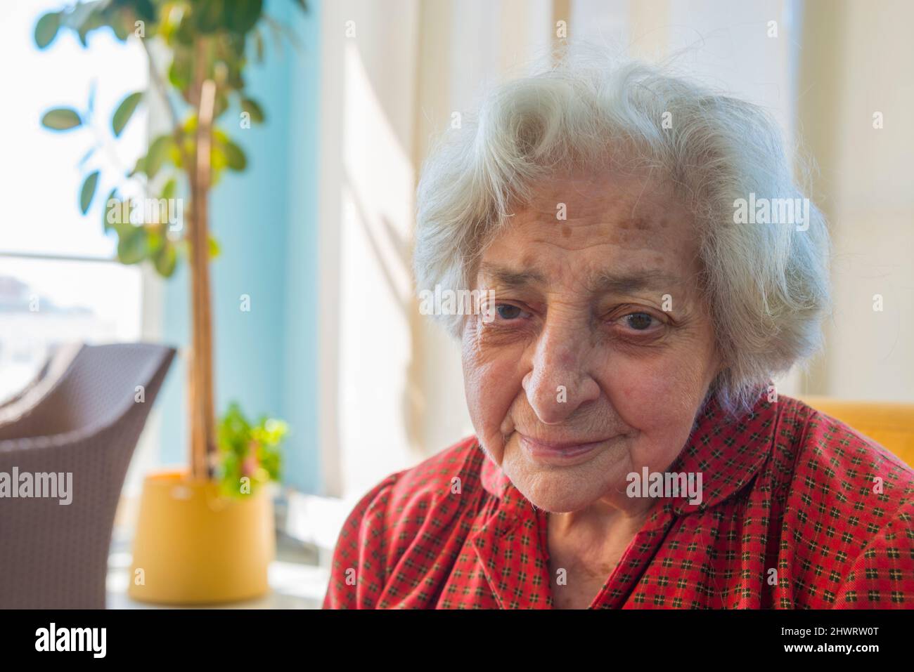 Elderly woman in a nursing home, looking at the camera. Stock Photo