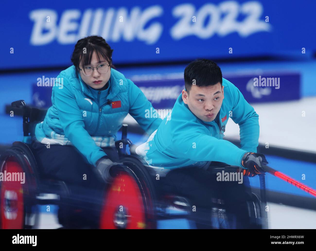 Beijing, China. 7th Mar, 2022. Zhang Mingliang (R) of China competes ...