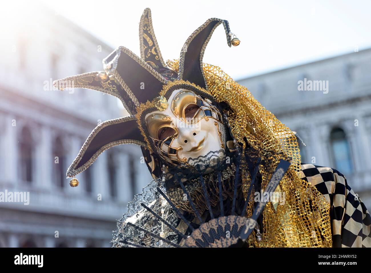 Woman in a beautiful traditional venetian costume and mask posing at the Venice carneval. St. Mark's Square, Venice Stock Photo