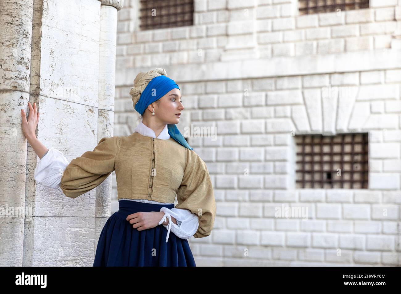 Woman in a beautiful traditional venetian costume and mask posing like Vermeer’s Girl With a Pearl Earring at the Venice carneval, venice, Italy Stock Photo