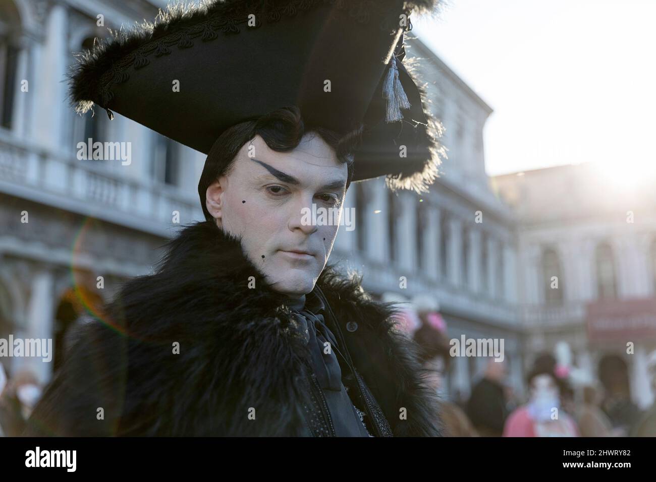 Man in a beautiful traditional venetian costume and mask posing at the Venice carneval. St. Mark's Square, Venice Stock Photo